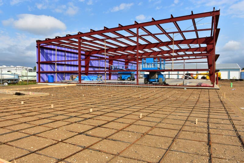 Reinforcement rod and steel framing members of new commercial building under construction in industrial area of city. Reinforcement rod and steel framing members of new commercial building under construction in industrial area of city