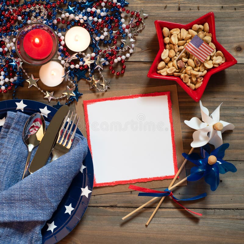 Fourth of July Rustic Table Place Setting in Red, White and Blue Colors with Menu or Invite Card with Copy Space.  A Square crop with above view and flat layout. Fourth of July Rustic Table Place Setting in Red, White and Blue Colors with Menu or Invite Card with Copy Space.  A Square crop with above view and flat layout