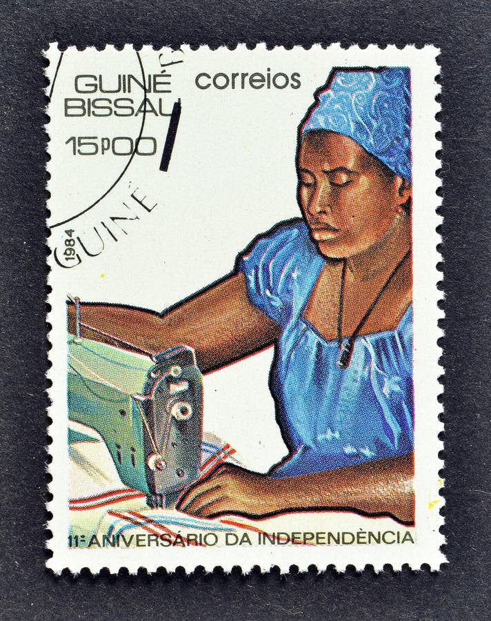 Cancelled postage stamp printed by Guinea Bissau, that shows Seamstress, celebrating 11th Anniversary of Independence, circa 1984. Cancelled postage stamp printed by Guinea Bissau, that shows Seamstress, celebrating 11th Anniversary of Independence, circa 1984.