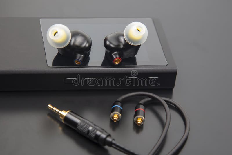 In-ear headphones for Hi-Fi music player. Audio sound and modern equipment for music lovers and audiophiles