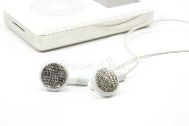 Earbuds next to a MP3 player on a white background. Earbuds next to a MP3 player on a white background
