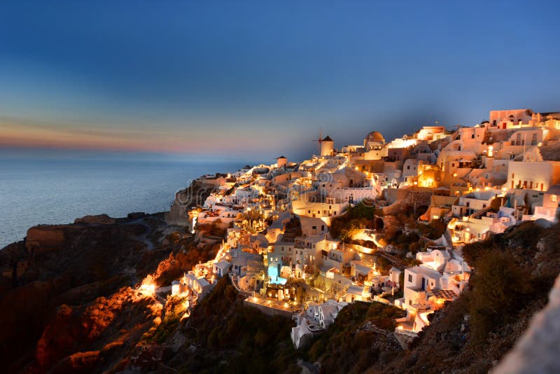 Early evening lights in Oia. Santorini, Cyclades islands. Greece