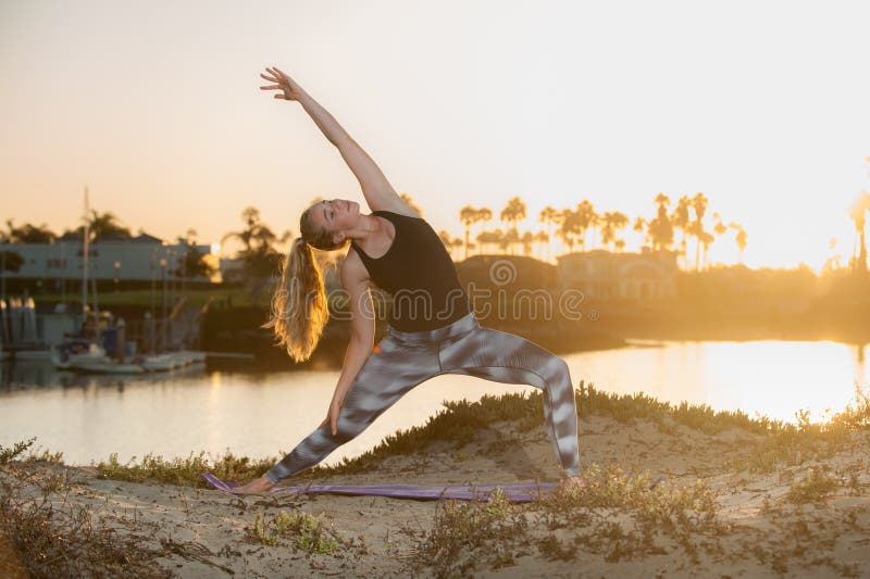 Early morning stretch at beach has blond reaching for the sky. royalty free stock images Early morning stretch at beach has blond reaching for the sky. royalty free stock images