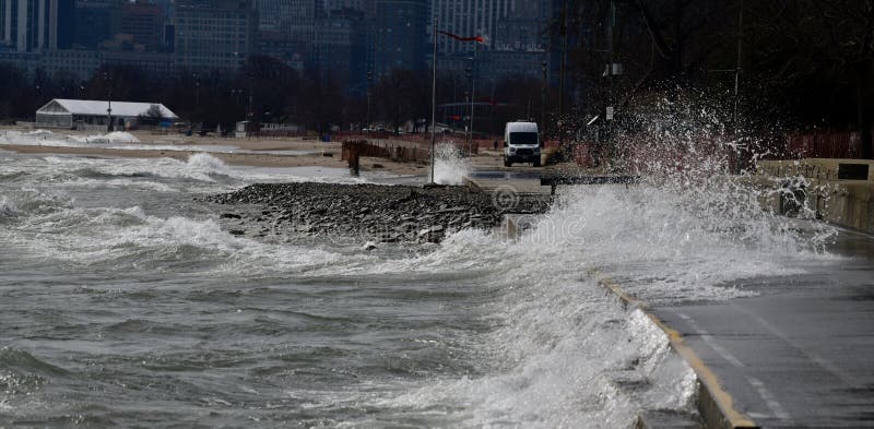 Crashing Waves draining Crashing on the Lakefront Walkway stock photos Crashing Waves draining Crashing on the Lakefront Walkway stock photos