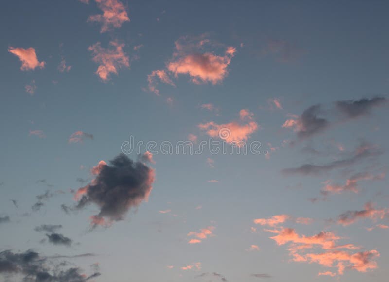 Pretty blue skies with pink and purple clouds.