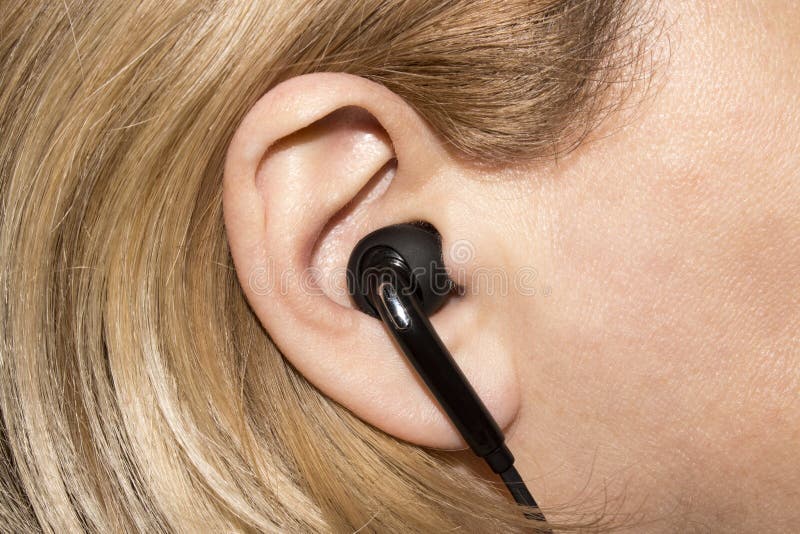 Earpiece in the human ear. stock photo. Image of attractive 137893608