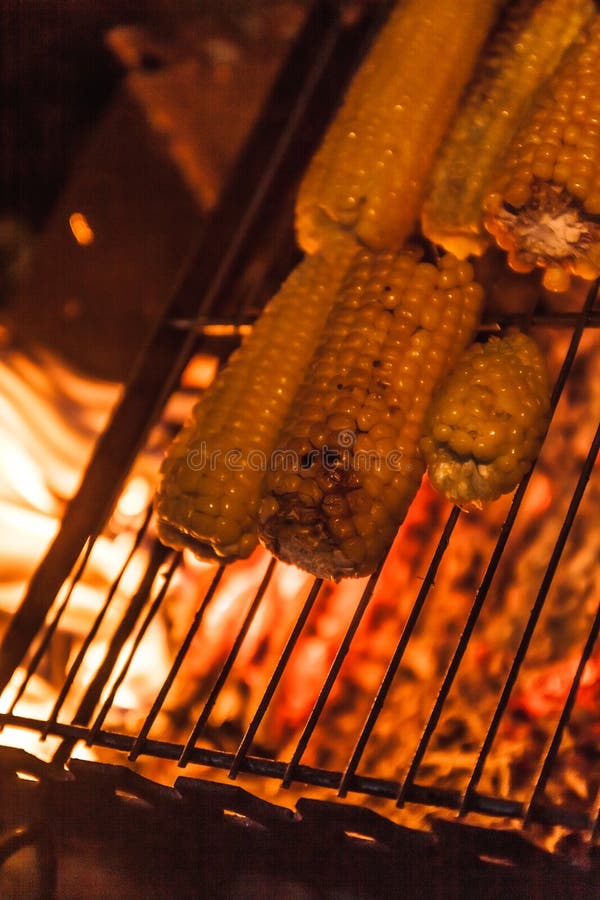 Ears of Corn on a Grill Over High Heat, Night Shooting. Stock Photo