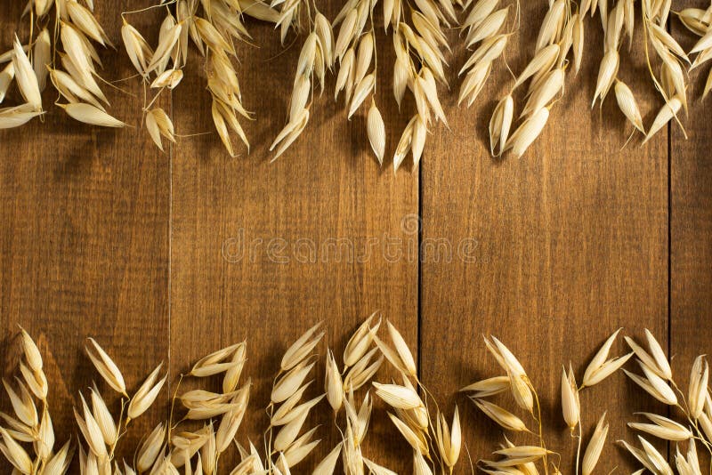 Ears of oat on wood