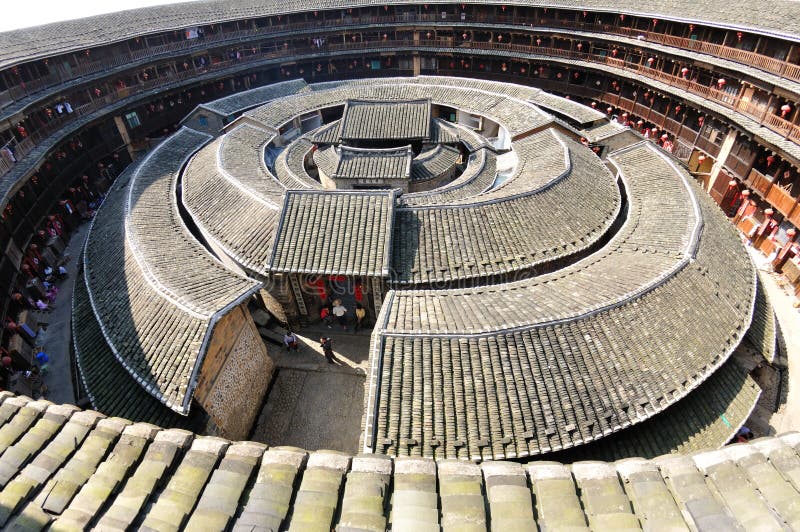 Earthen houses represent a vernacular architecture specific to Jiangxi, Fujian and Guangdong provinces following the flow of the Hakka people from central China to the South. As most Hakka resided in mountains, communal houses made of compacted earth were built to provide protection against bandits and wild animals. The older examples of this style of construction consist of interior buildings enclosed by huge peripheral ones holding hundreds of rooms and dwellers. With all the halls, storehouses, wells and bedrooms inside, the huge towerlike building functions almost as a small fortified city. Earthen houses are made of earth, stone, bamboo and wood, all readily available materials. After constructing the walls with rammed earth, branches, strips of wood and bamboo chips were laid in the wall as bones to reinforce it. The end result is a well lit, well-ventilated, windproof, quakeproof building that is warm in winter and cool in summer. Earthen houses represent a vernacular architecture specific to Jiangxi, Fujian and Guangdong provinces following the flow of the Hakka people from central China to the South. As most Hakka resided in mountains, communal houses made of compacted earth were built to provide protection against bandits and wild animals. The older examples of this style of construction consist of interior buildings enclosed by huge peripheral ones holding hundreds of rooms and dwellers. With all the halls, storehouses, wells and bedrooms inside, the huge towerlike building functions almost as a small fortified city. Earthen houses are made of earth, stone, bamboo and wood, all readily available materials. After constructing the walls with rammed earth, branches, strips of wood and bamboo chips were laid in the wall as bones to reinforce it. The end result is a well lit, well-ventilated, windproof, quakeproof building that is warm in winter and cool in summer.