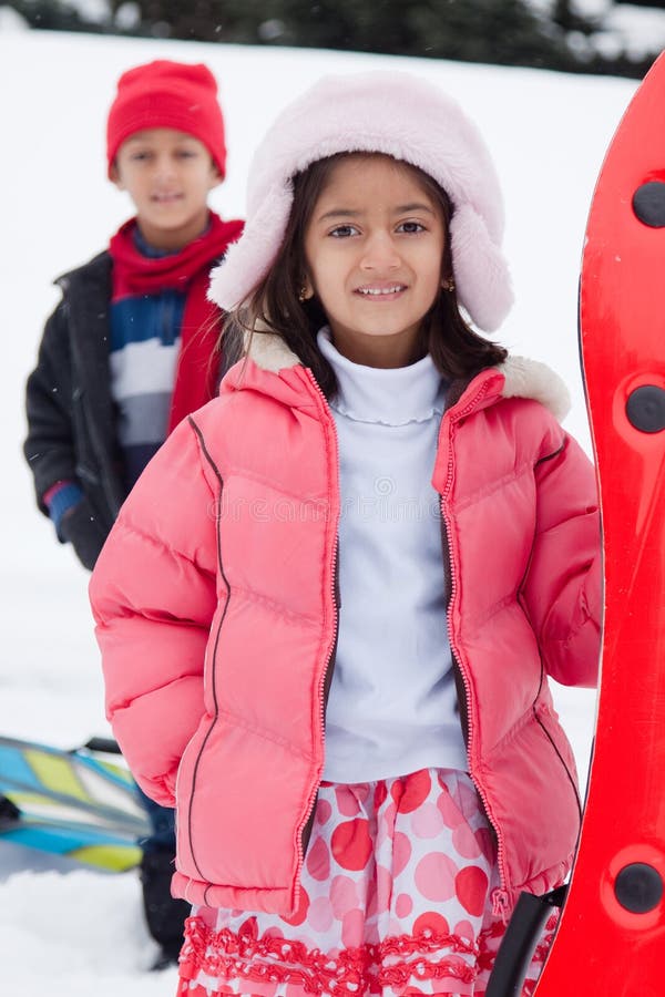 East Indian kids toboganning in the snow royalty free stock image East Indian kids toboganning in the snow royalty free stock image