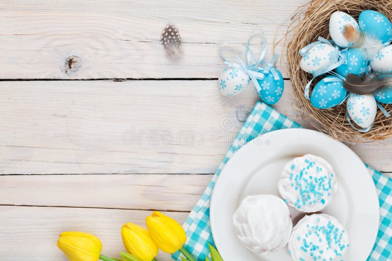 Easter background with blue and white eggs in nest, yellow tulip