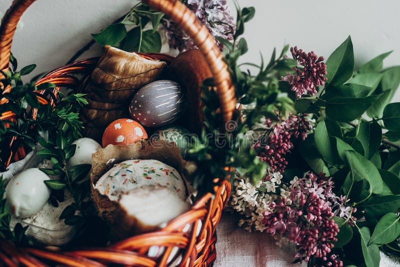 easter basket with cake and eggs ham food. colorful decorated egg with floral and chicken ornaments and lilac flowers. space for stock photography easter basket with cake and eggs ham food. colorful decorated egg with floral and chicken ornaments and lilac flowers. space for stock photography