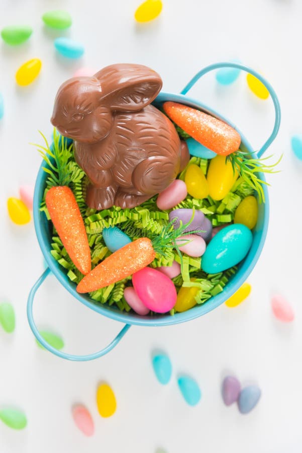 Easter Basket with Chocolate Rabbit, Candy Eggs, and Mini Carrots on