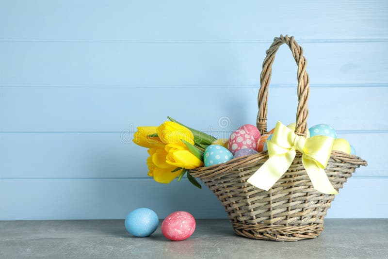 Easter Basket Filled with Colorful Eggs and Flowers on a Background ...