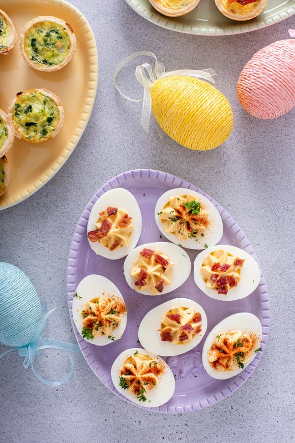 Easter brunch appetizers deviled eggs and mini quiches royalty free stock images