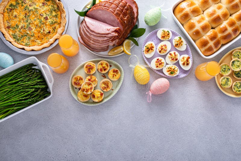 Easter brunch table with ham, quiche, hot cross buns stock photography
