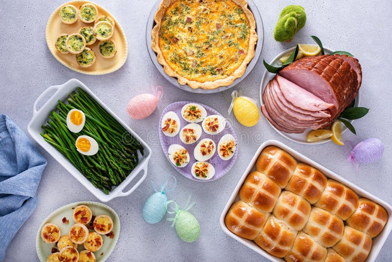 Easter brunch table with ham, quiche, hot cross buns royalty free stock photo