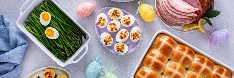 Easter brunch table with ham, quiche, hot cross buns stock image