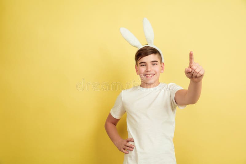 Easter Bunny Boy with Bright Emotions on Yellow Studio Background Stock ...