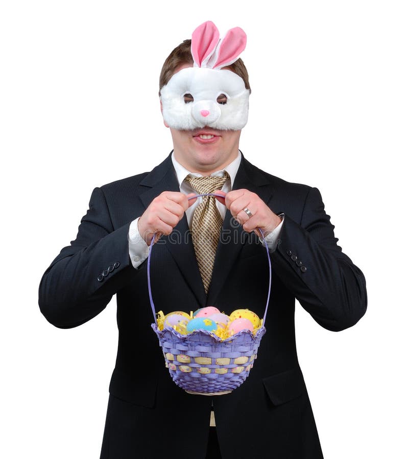 Easter Bunny Outfit 1. Young man wearing suit with Easter Bunny mask, holding an Easter basket full of brightly coloured eggs royalty free stock photos Easter Bunny Outfit 1. Young man wearing suit with Easter Bunny mask, holding an Easter basket full of brightly coloured eggs royalty free stock photos