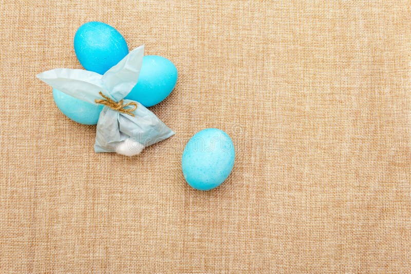 Easter bunny rabbit paper gift egg wrapping idea. Handicraft homemade concept for children kids. On cloth linen background royalty free stock photography Easter bunny rabbit paper gift egg wrapping idea. Handicraft homemade concept for children kids. On cloth linen background royalty free stock photography