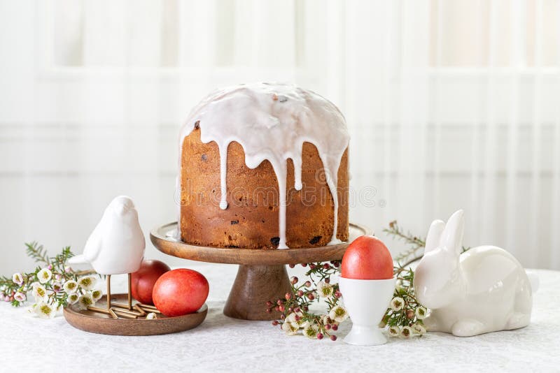 Easter cake or sweet bread decorated with white icing, red coloured Paschal eggs