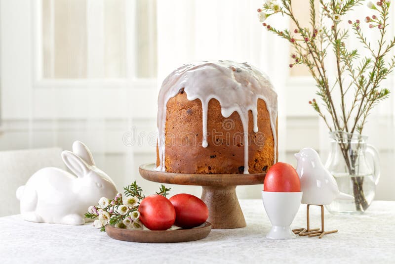 Easter cake or sweet bread decorated with white icing, red coloured Paschal eggs