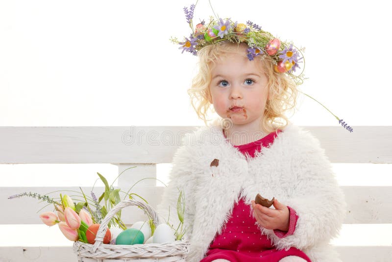 Easter child eating chocolate eggs
