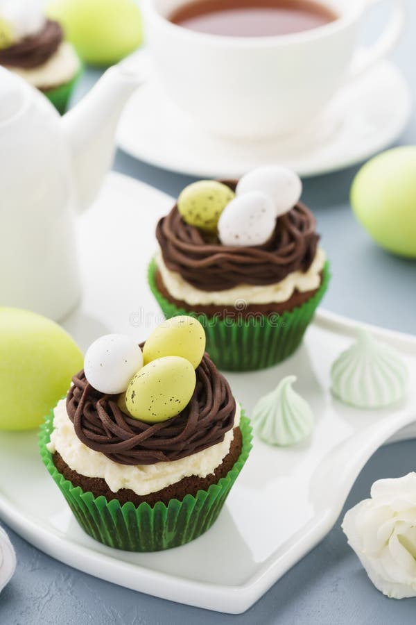 Easter Chocolate Cupcakes with Nest, Candy Eggs and Tea Stock Photo