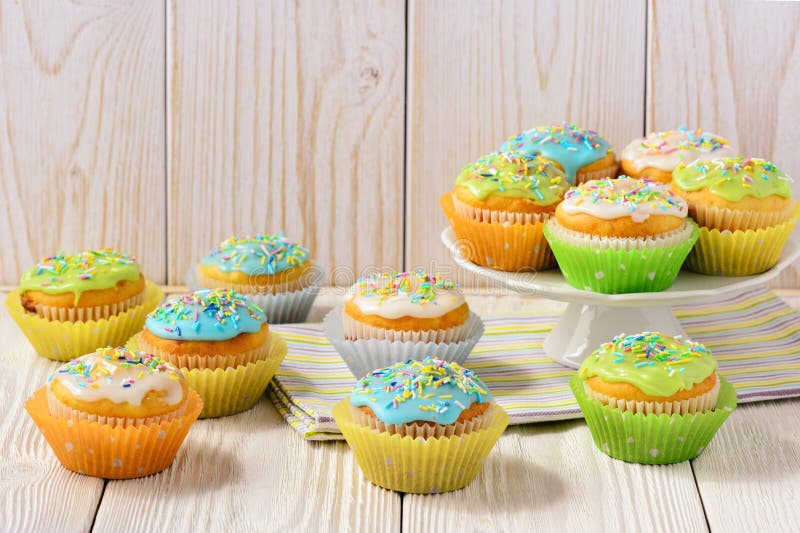 Easter colorful muffins on white table.