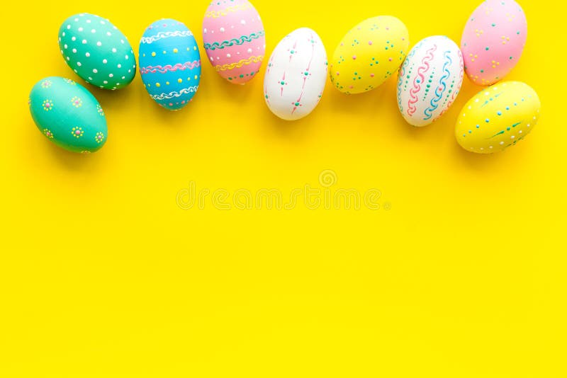 Easter Composition. Decorated Pastel Easter Eggs on Yellow Background
