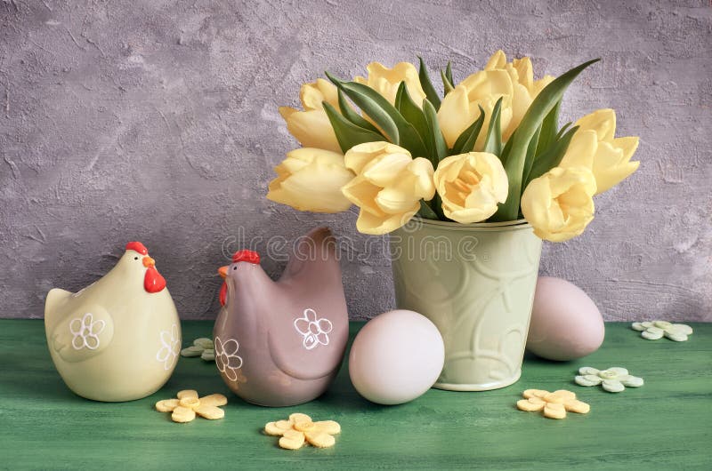Easter composition with yellow tulips, felt flowers, ceramic hens and Easter eggs royalty free stock images