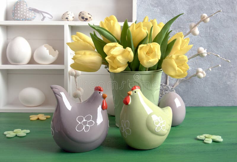 Easter composition with yellow tulips, ceramic hens and Easter e stock photo