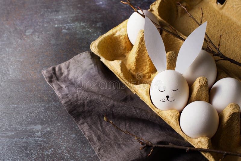 Easter Dark Flat Lay Concept with Eggs in Carton and Bunny Egg in
