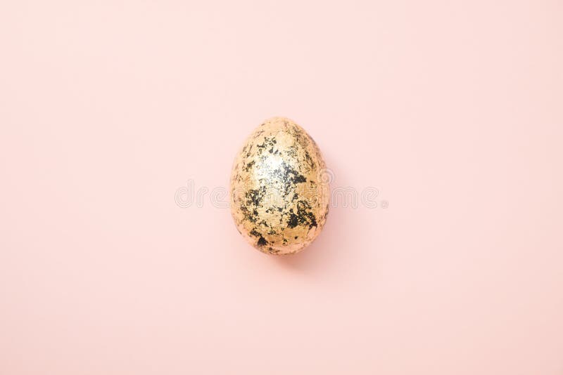 Easter decorated with golden potal egg on pastel pink background. Minimal easter concept. Happy Easter card. Top view, flatlay.