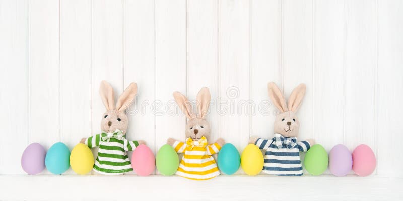 Easter decoration eggs funny bunnies wooden background