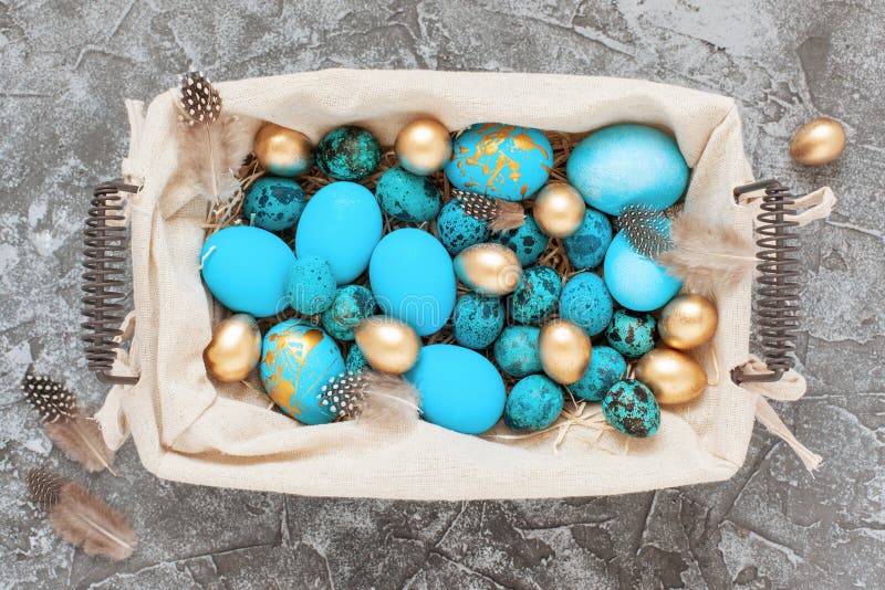 Easter Eggs in Basket on Gray Concrete Background. Top View, Flat Lay