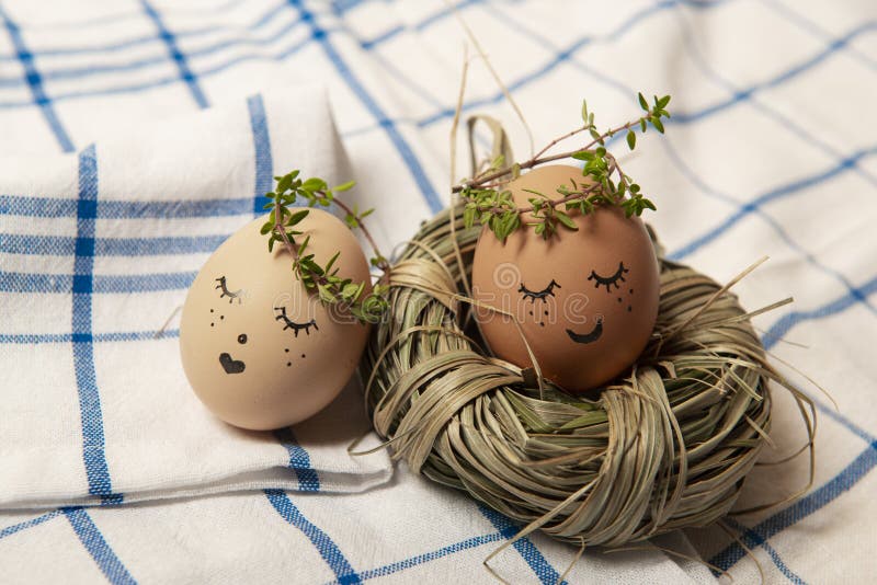 Easter eggs with cute face in green plant wreath. Sleepy easter eggs - Home crafts happy easter concept royalty free stock photography