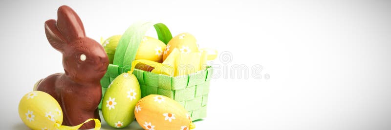Easter eggs in a basket with chocolate bunny
