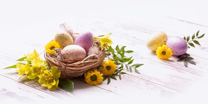 Easter eggs in a nest of straw and flowers