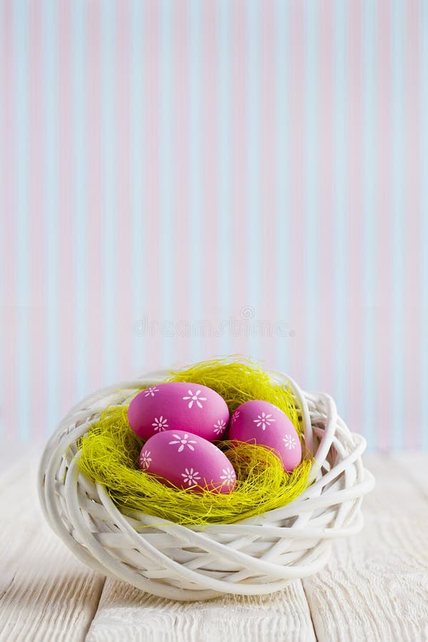 Easter eggs in the nest and wooden table on patterned background stock photos Easter eggs in the nest and wooden table on patterned background stock photos