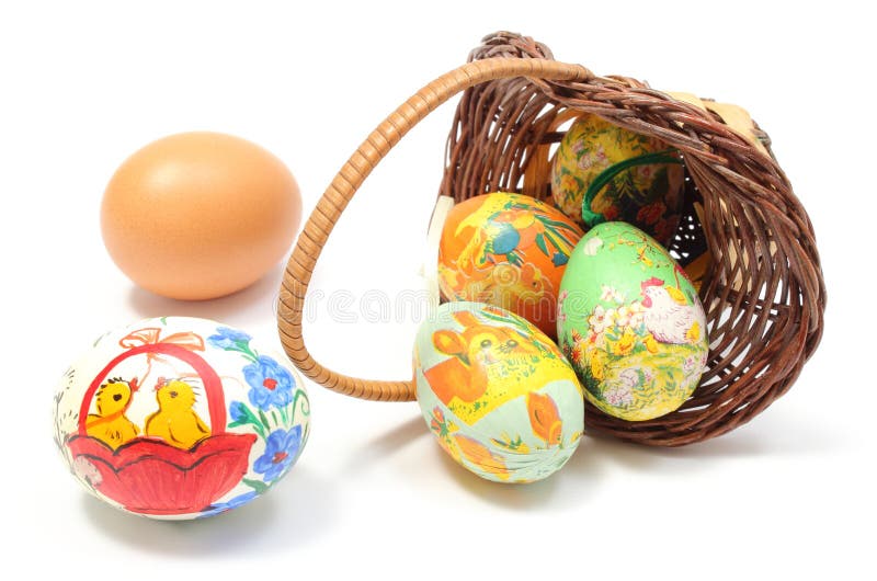 Easter eggs in overturned wicker basket stock photos