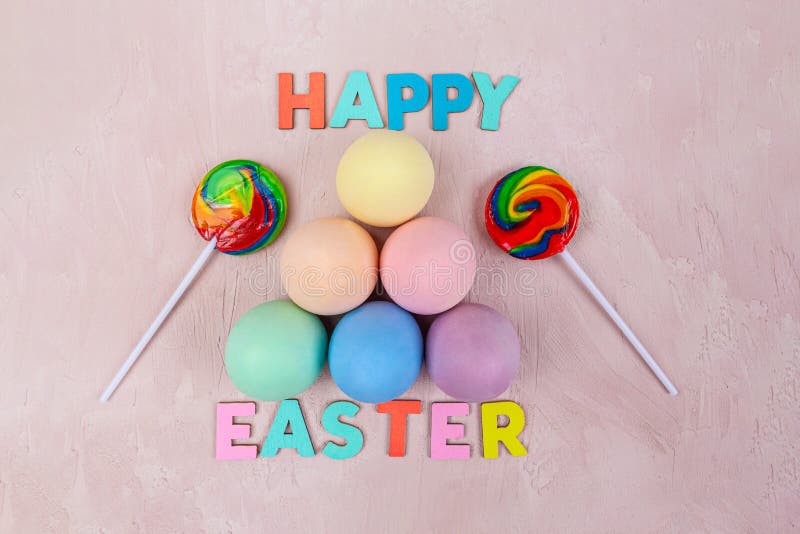 Easter Eggs Painted in Plain Colors and Lollies with Happy Easter Text