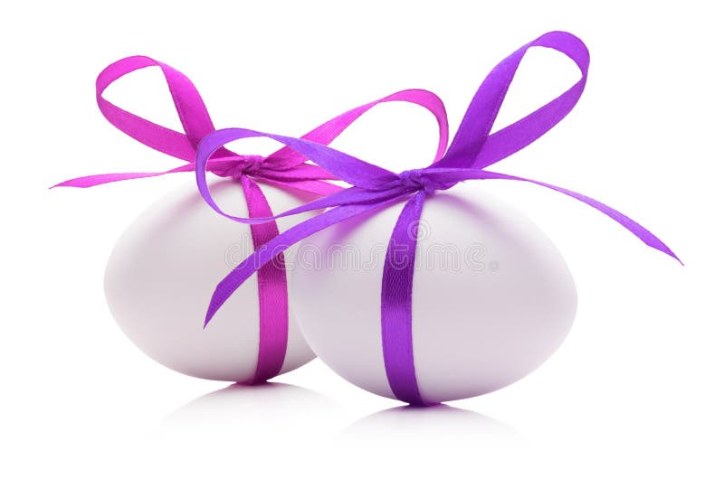 Easter eggs with pink and purple ribbons isolated on the white