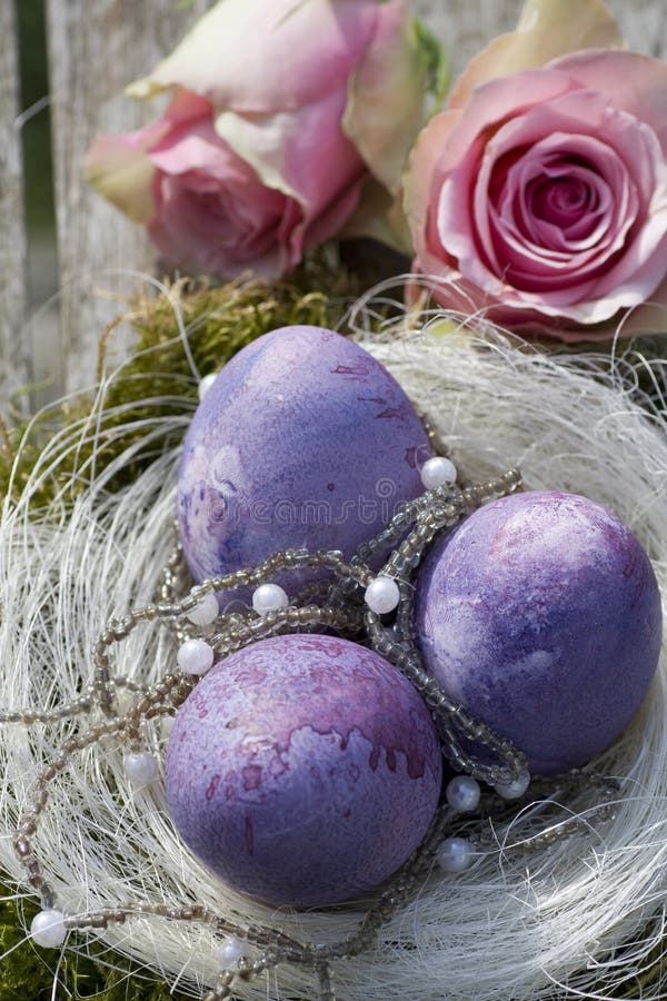 Easter eggs in purple with roses and pearls