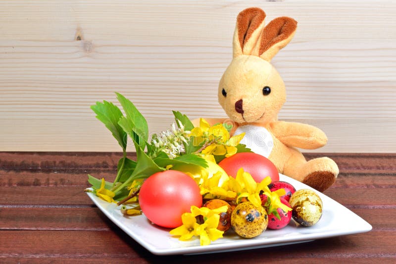 Easter eggs, spring flowers and a rabbit toy royalty free stock photos