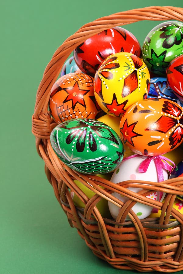 Easter Eggs in wicker basket on green