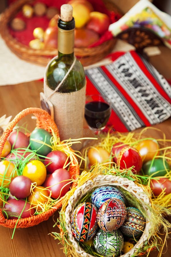 Easter eggs wine and ornaments on table