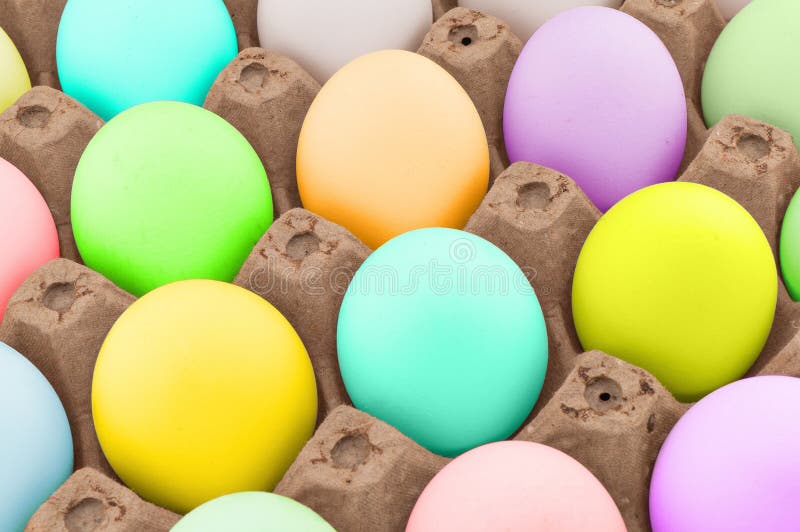 Easter eggs in wooden box texture background. Rainbow colored Easter eggs pattern. Group of easter eggs in a row