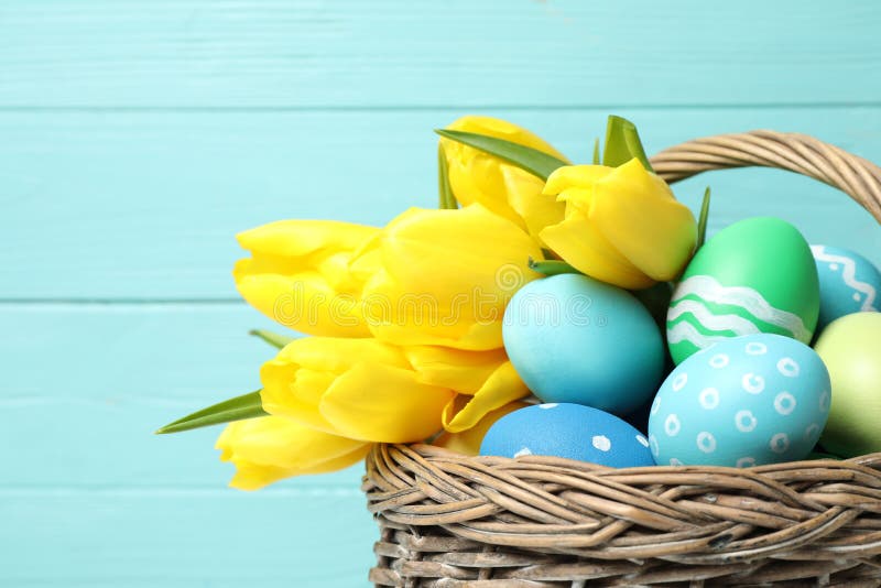 Easter Eggs and Yellow Tulips in Wicker Basket on Blue Background ...